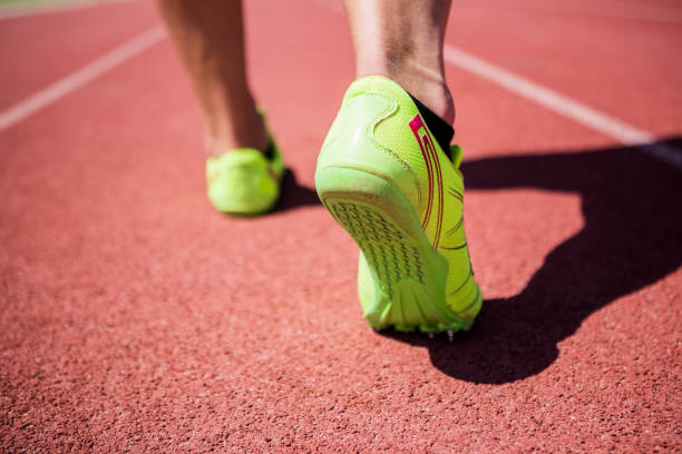 istock Athletes feet running on the racing track 661268136