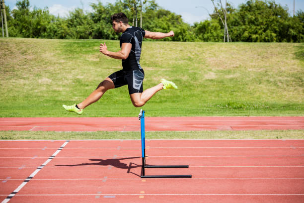 istock Athlete jumping above the hurdle 661286390