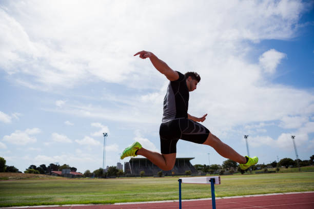 istock Athlete jumping above the hurdle 661286584