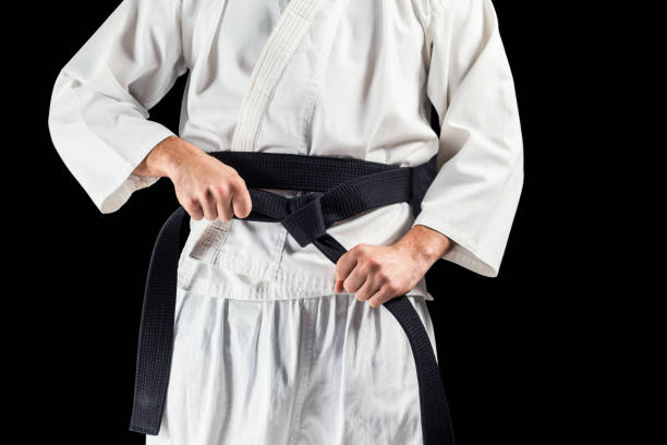 istock Mid section of fighter tightening karate belt 661297200