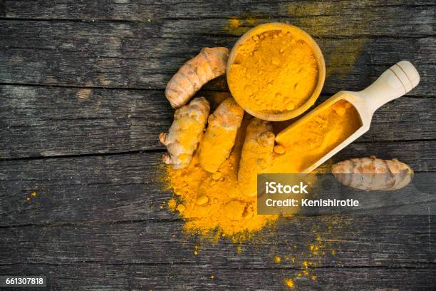 Turmeric Roots And Turmeric Powder Stock Photo - Download Image Now - Turmeric, Bowl, Condiment