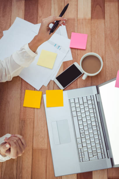 istock Cropped image of woman with pen using laptop 661308482