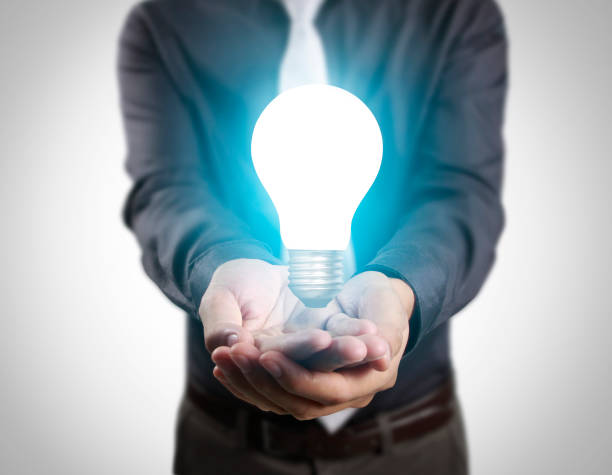 istock business person holding light bulb 661327774