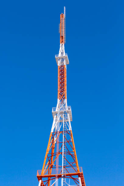 istock Telecommunication towers with antennas on blue sky. View from the bottom. 661329546