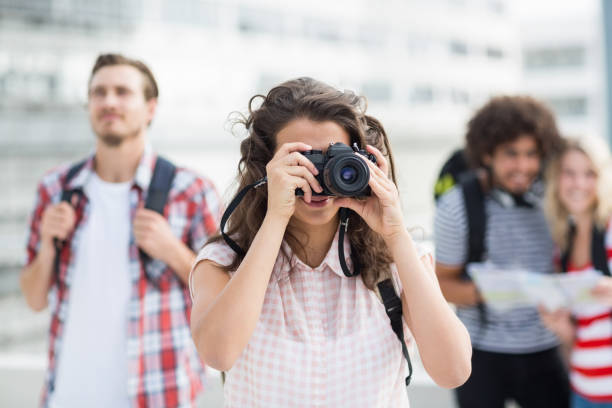 istock Woman wearing backpack taking photo 661337318