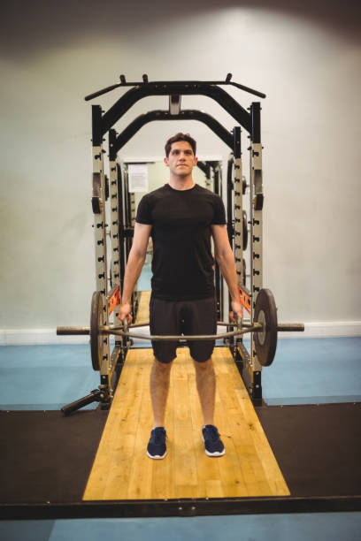istock Fit man lifting heavy barbell 661349334