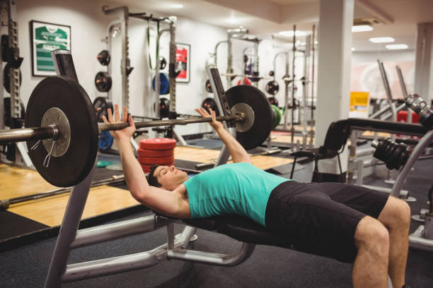 istock Fit man lifting heavy barbell 661350464