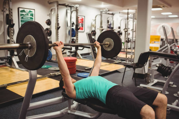 istock Fit man lifting heavy barbell 661350834
