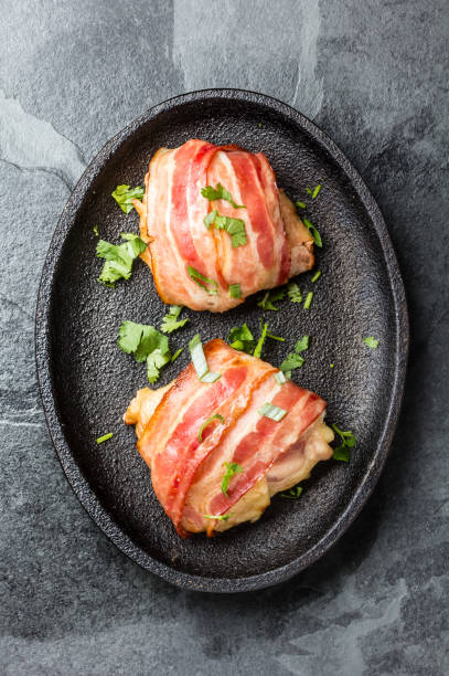 istock Baked chicken wrapped in bacon on iron plate 661370730