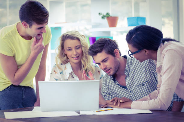 istock Creative business team working on a laptop together 661399146