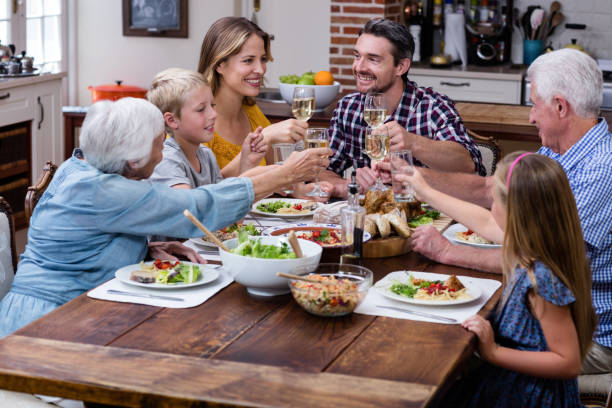 istock Multi-generation family toasting glass of wine while having meal 661400414