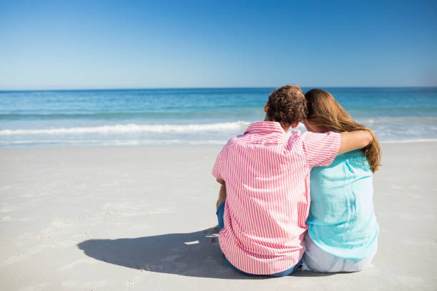 istock Happy couple posing on the beach 661409264