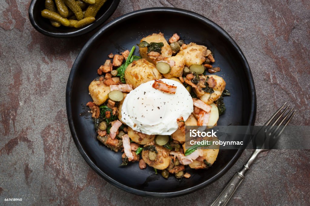 Potato and  Spinach Hash with Cornichons and Bacon Potato and spinach hash with cornichons, bacon and poached egg.  Top view.Potato and spinach hash with cornichons and bacon. Hash - Food Stock Photo