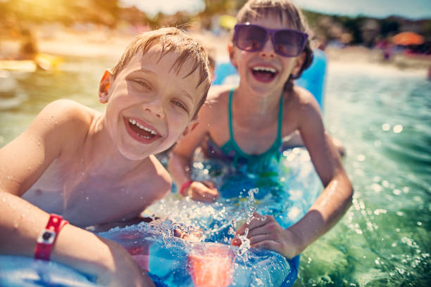 istock Brother and sister having fun in sea 661422962