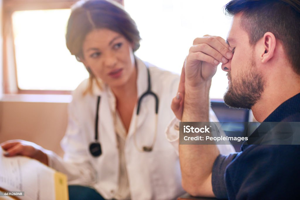 How long have you been experiencing these symptoms? Shot of a young doctor consulting with a patient in her office Doctor Stock Photo
