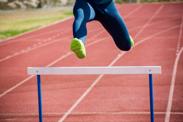 istock Athlete jumping above the hurdle 661426128