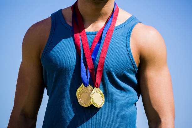 istock Athlete posing with gold medals around his neck 661428544