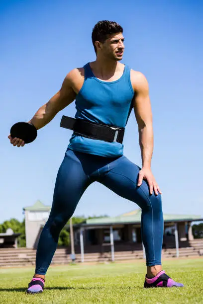 Athlete about to throw a discus in stadium