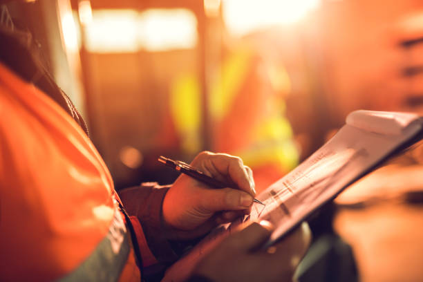 istock Close up of unrecognizable worker signing reports. 661429380