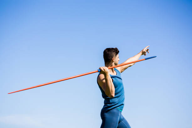 Athlete about to throw a javelin Determined athlete about to throw a javelin in the stadium javelin stock pictures, royalty-free photos & images
