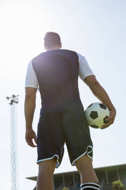 istock Low angle view of a soccer player with a ball 661432810