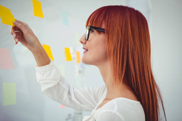 istock Attractive hipster woman holding  sticky notes 661436838