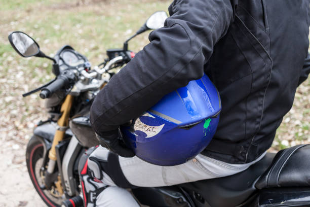 istock Biker sitting on motorcycle, holding his blue helmet. 661439220