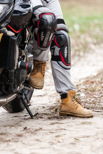 istock Biker sitting on motorcycle, close-up view on legs. 661440052