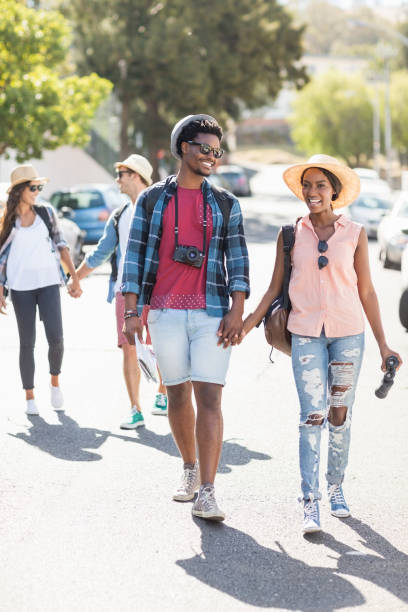 istock Young couple walking on road 661440636