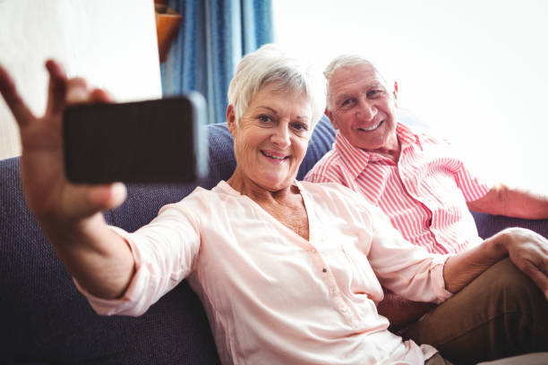 istock Smiling senior couple taking a selfie 661449728