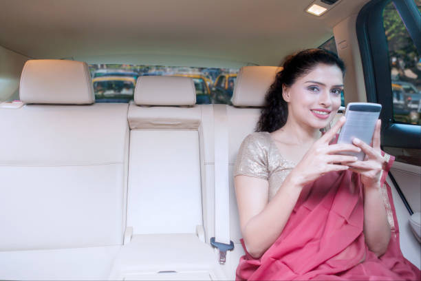 Indian woman uses cellphone in car