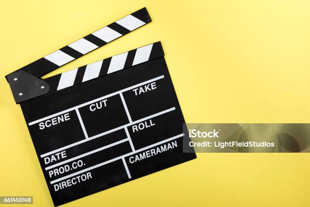 Top View Of Movie Clapper Board On Yellow Stock Photo - Download Image Now - Movie Ticket, Yellow, Arts Culture and Entertainment