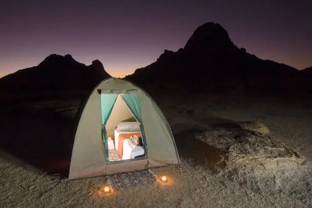 Photo of A tent kitted out with luxury bed and bedding