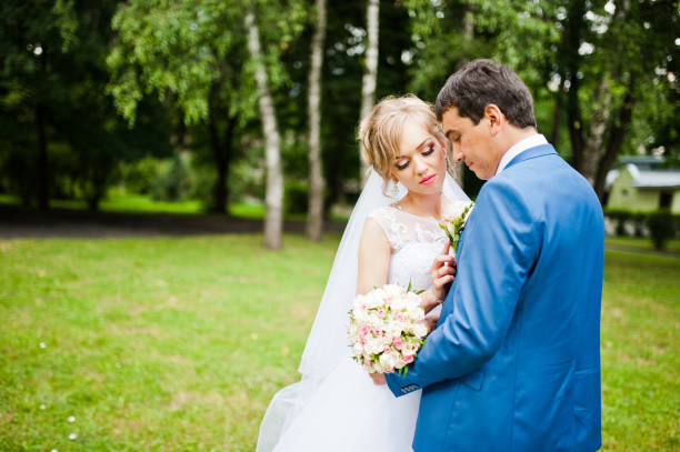 istock wedding couple in love walking in park 661451738