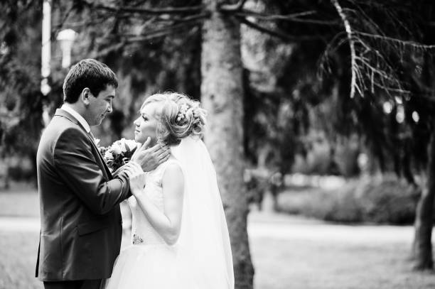 istock wedding couple in love walking in park 661451756
