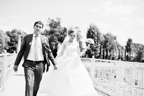 istock wedding couple in love walking in park 661455978