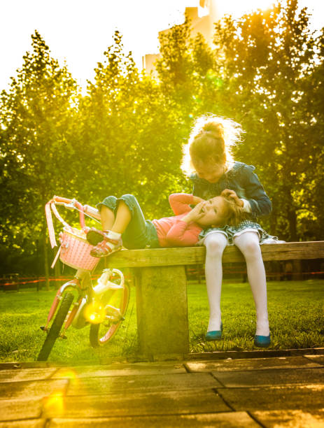 istock Two girls sitting on bench 661456166