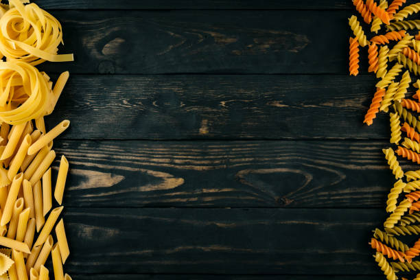 istock spaghetti  pasta on black wooden background top view 661460834