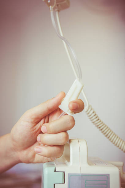 istock Nurse's hands regulation an intravenous (IV) drip in hospital room. 661461166