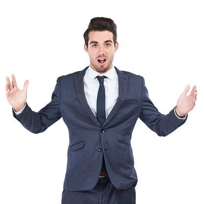 Studio shot of a young businessman looking surprised against a white background