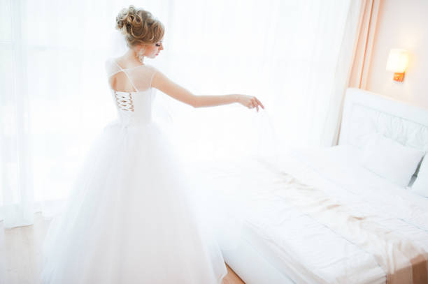 istock gentle blonde  bride on couch tenderly posed 661467798