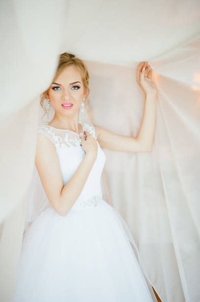 istock gentle blonde  bride on curtains tender posed 661467930
