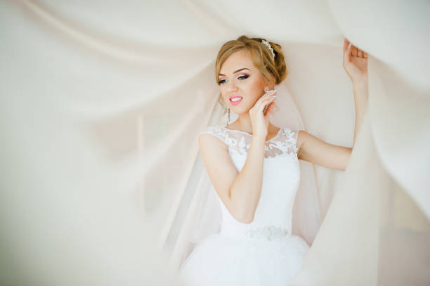 istock gentle blonde  bride on curtains tender posed 661467940