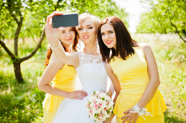 istock bride with bridesmaids at garden 661468210