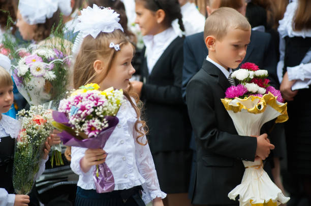 First-grade pupils with flowers. Tyumen stock photo