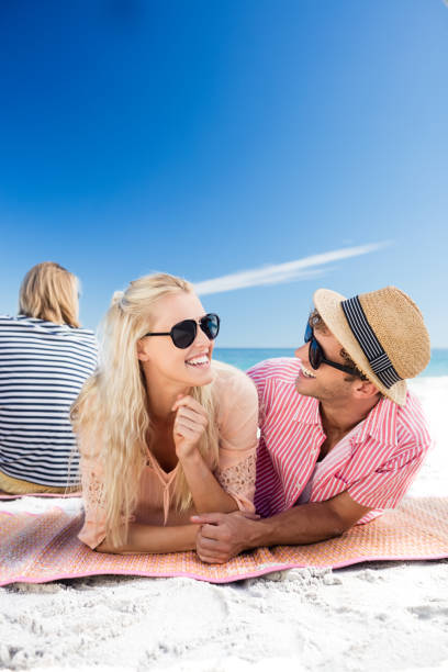 istock Friends lying on the beach 661477260