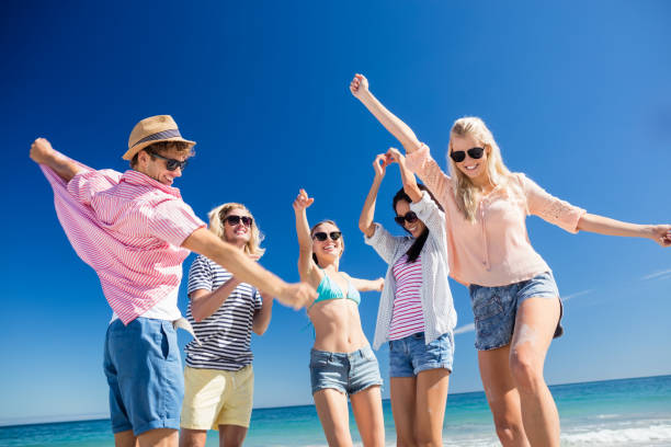 istock Friends  dancing on the beach 661478582