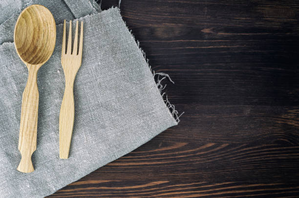 istock Wooden spoon and fork on gray napkin 661478600