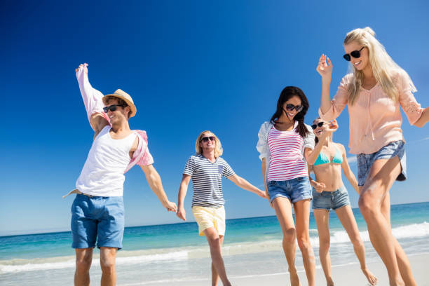 istock Friends  dancing on the beach 661481324