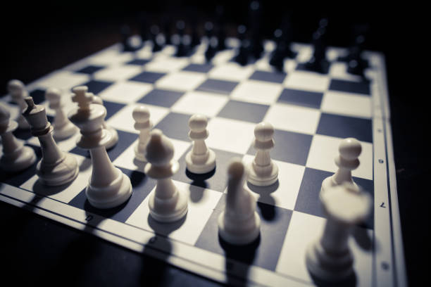 istock White and black pieces on a chess board 661481394